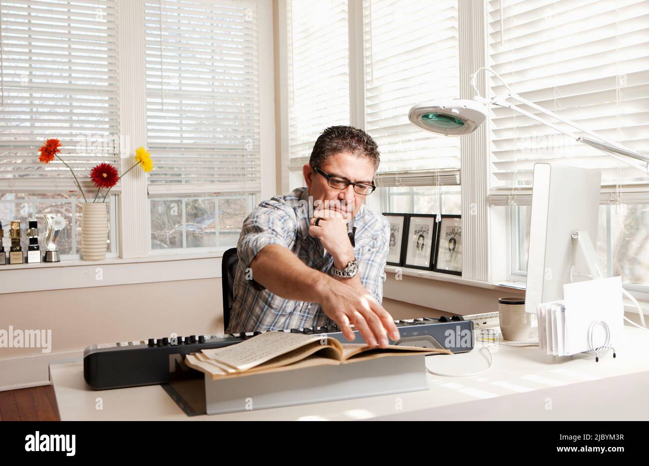 Man avec clavier électronique et partitions Banque D'Images