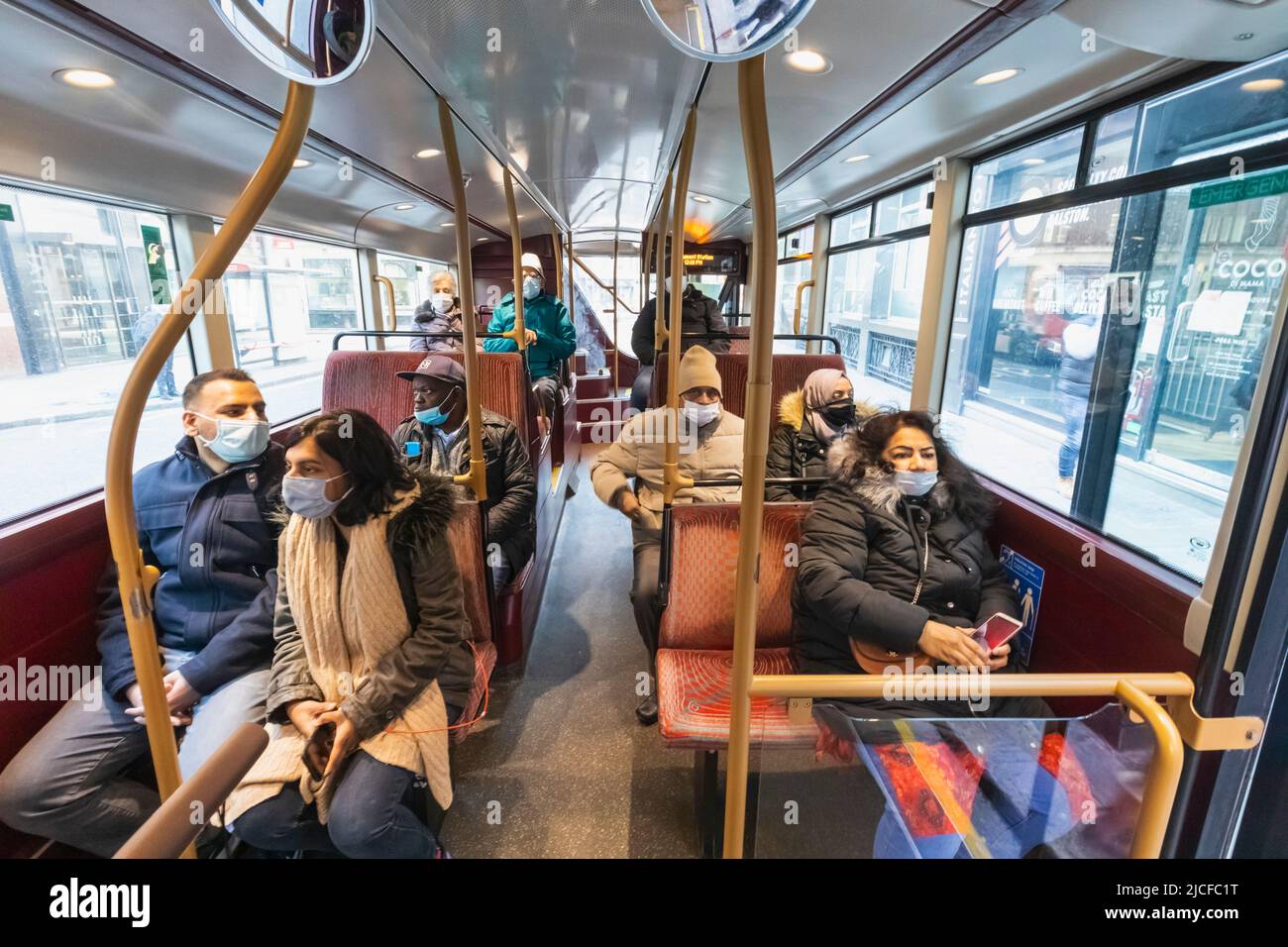 Angleterre, Londres, Groupe de passagers de bus assis portant des masques chirurgicaux Banque D'Images
