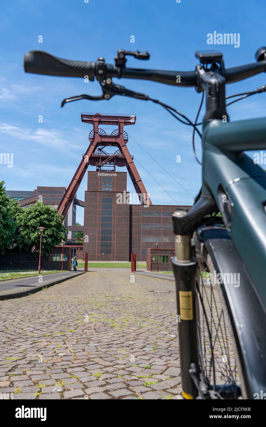 Vélo dans la région de la Ruhr, en vélo, e-bike, à la mine de charbon Zollverein site du patrimoine mondial, double tréstle cadre de la fosse Shaft XII, Essen, NRW, Allemagne, Banque D'Images