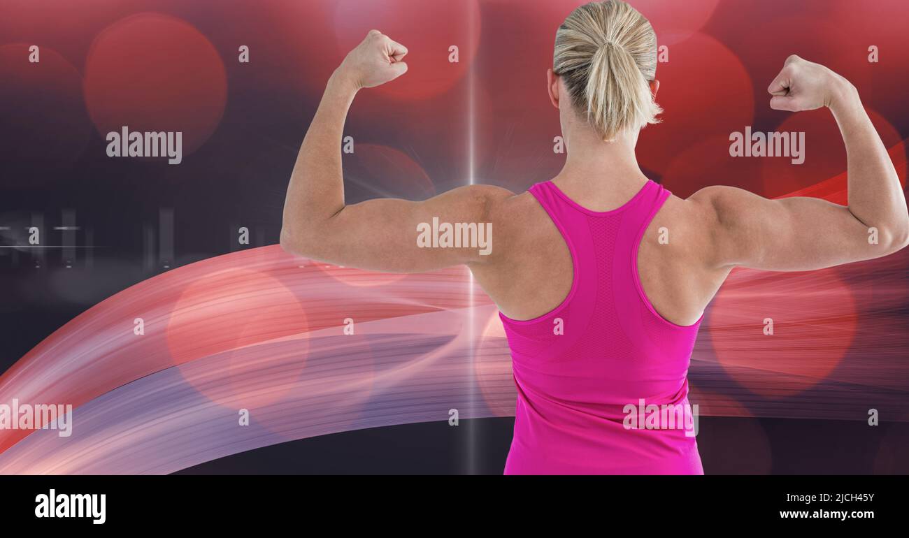 Image composite d'une femme de type caucasien qui plie son biceps contre les ondes numériques en arrière-plan Banque D'Images