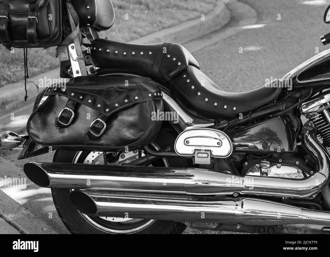 Siège en cuir de la moto ancienne extérieure. Siège de moto. Grand siège de vélo. Gros plan sur le siège et la roue de la moto. Concept de déplacement, mise au point sélective, frénésie Banque D'Images