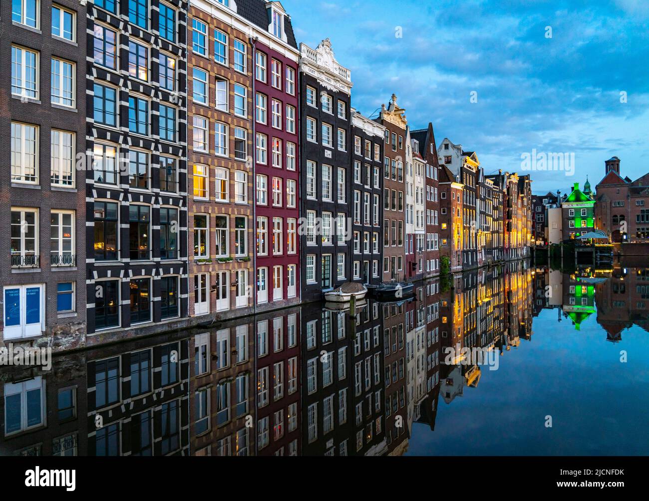Maisons de canal sur le Damrak, dans le centre de la vieille ville d'Amsterdam, port, point de départ de nombreuses visites de canal, soirée, pays-Bas, Banque D'Images