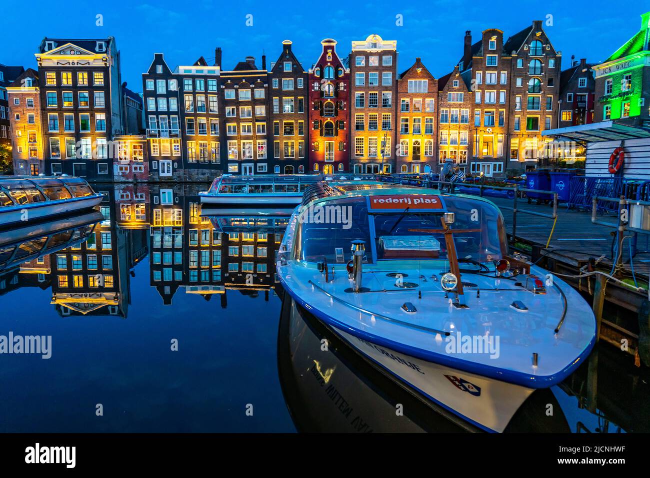 Maisons de canal sur le Damrak, dans le centre de la vieille ville d'Amsterdam, port, point de départ de nombreuses visites de canal, soirée, pays-Bas, Banque D'Images