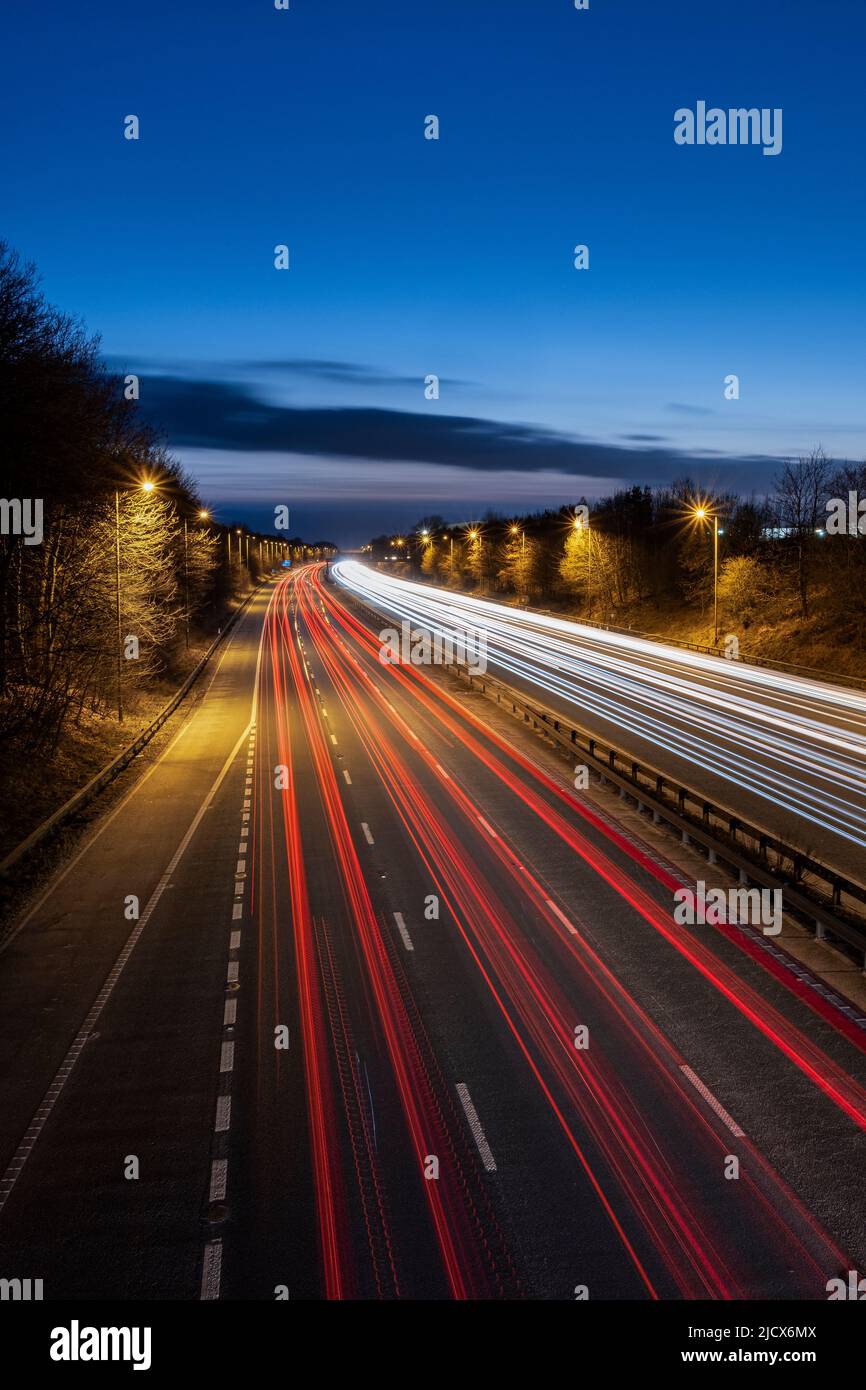 L'autoroute M56 de nuit avec des sentiers de circulation en direction de l'ouest, Cheshire, Angleterre, Royaume-Uni, Europe Banque D'Images