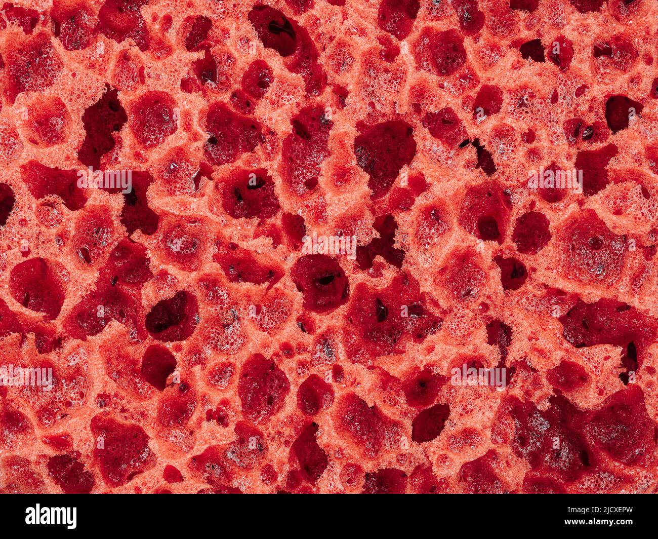 Texture rouge de l'éponge de décor comme arrière-plan abstrait Banque D'Images