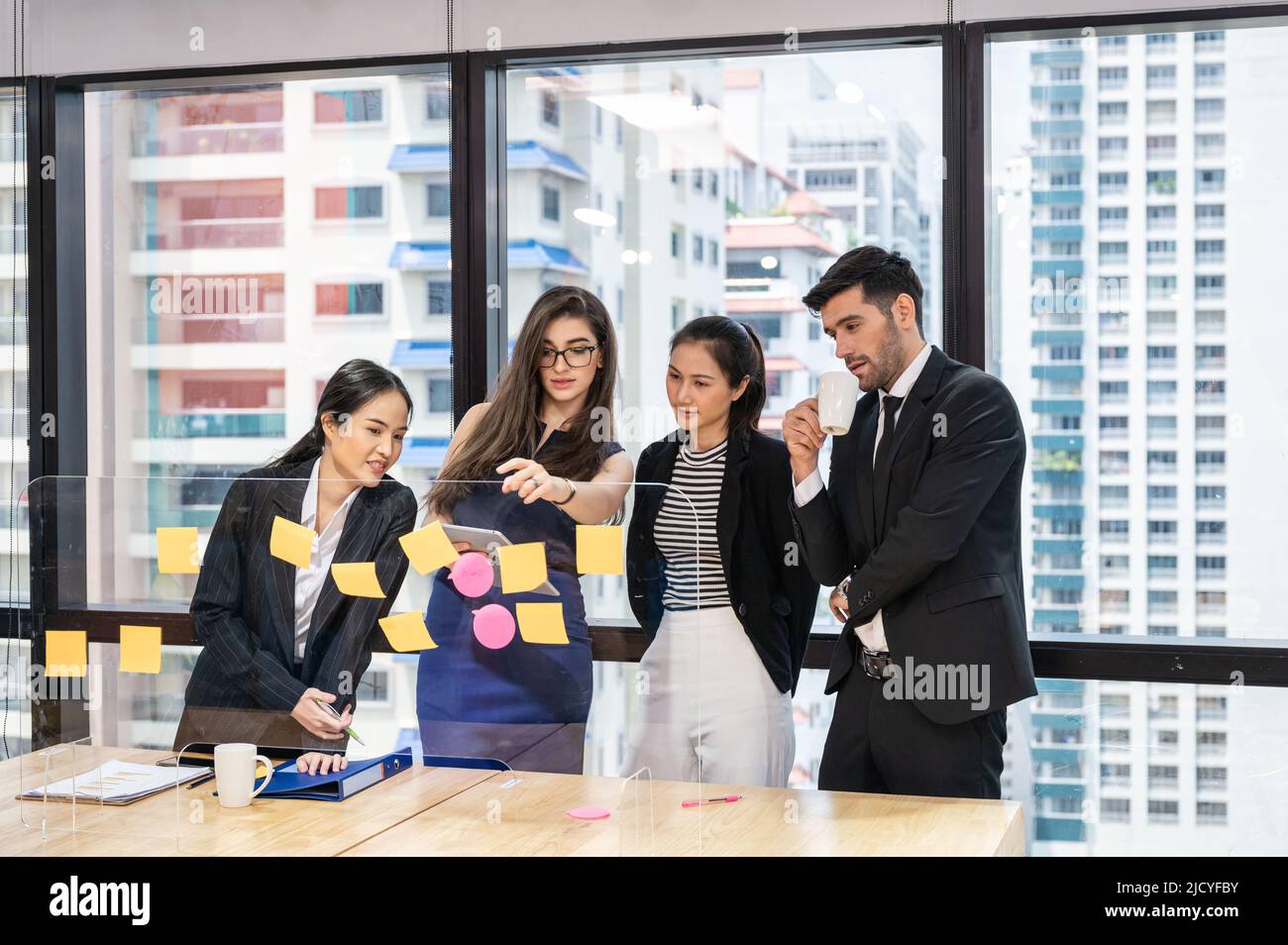 Groupe créatif multiethnique de gens d'affaires de brainstorming et d'utiliser des notes adhésives sur le bureau de partition dans le bureau moderne du quartier des affaires Banque D'Images