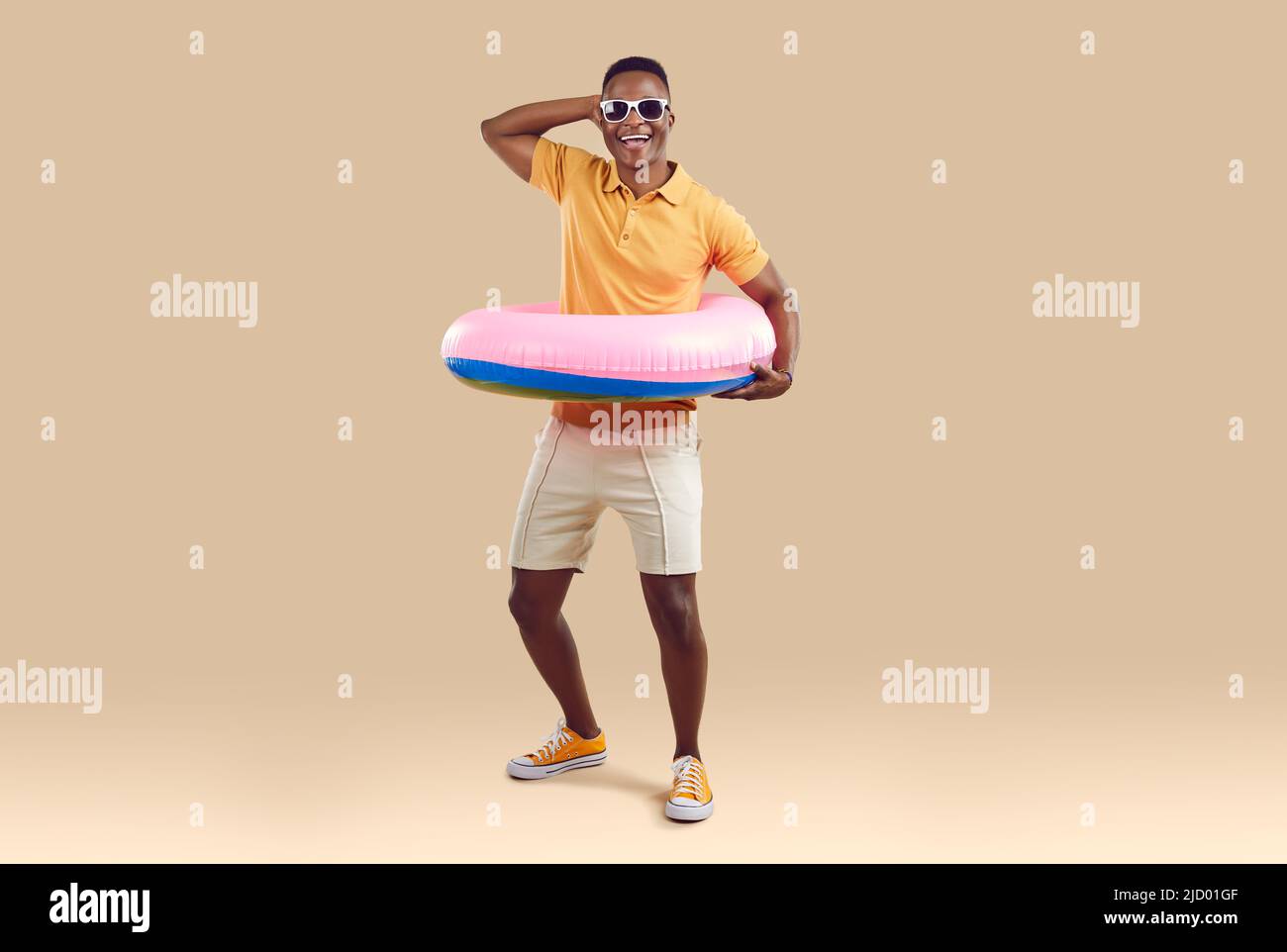 Drôle africain américain homme ayant le plaisir avec cercle gonflable pour nager à la taille. Banque D'Images