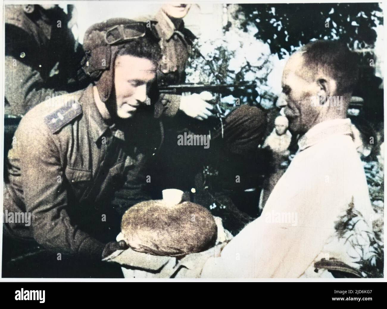 Un fermier ukrainien accueille une équipe de réservoir soviétique avec des cadeaux traditionnels - du pain et du sel. Version colorisée de : 10059597 Date: 1944 - 1945 Banque D'Images