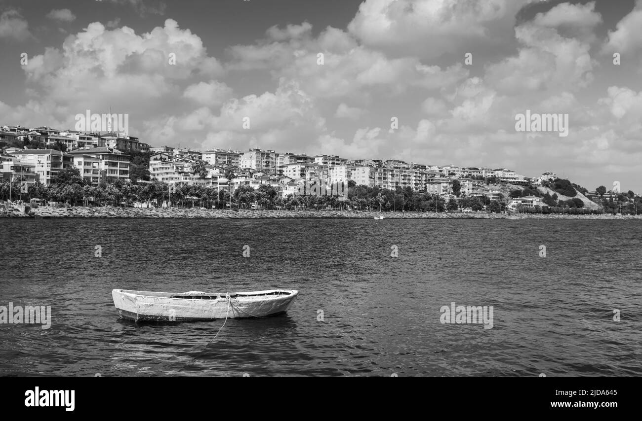 Le bateau en bois blanc est ancré dans le quartier d'Avcilar, dans la ville d'Istanbul, en Turquie. Photo en noir et blanc Banque D'Images