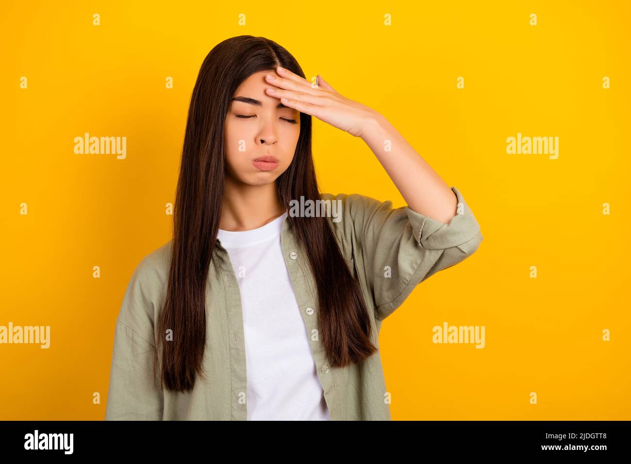 Photo de la jeune femme d'affaires stressée employée de bureau se sentent fatiguée après une dure journée isolée sur fond jaune de couleur Banque D'Images