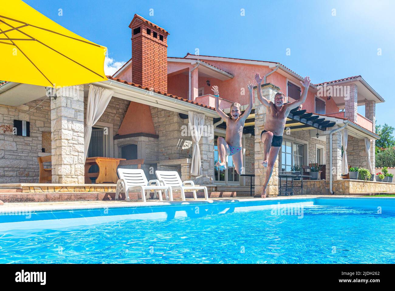 Croatie, Istrie, Pula, blonde fille et grand-père s'amuser à la piscine Banque D'Images