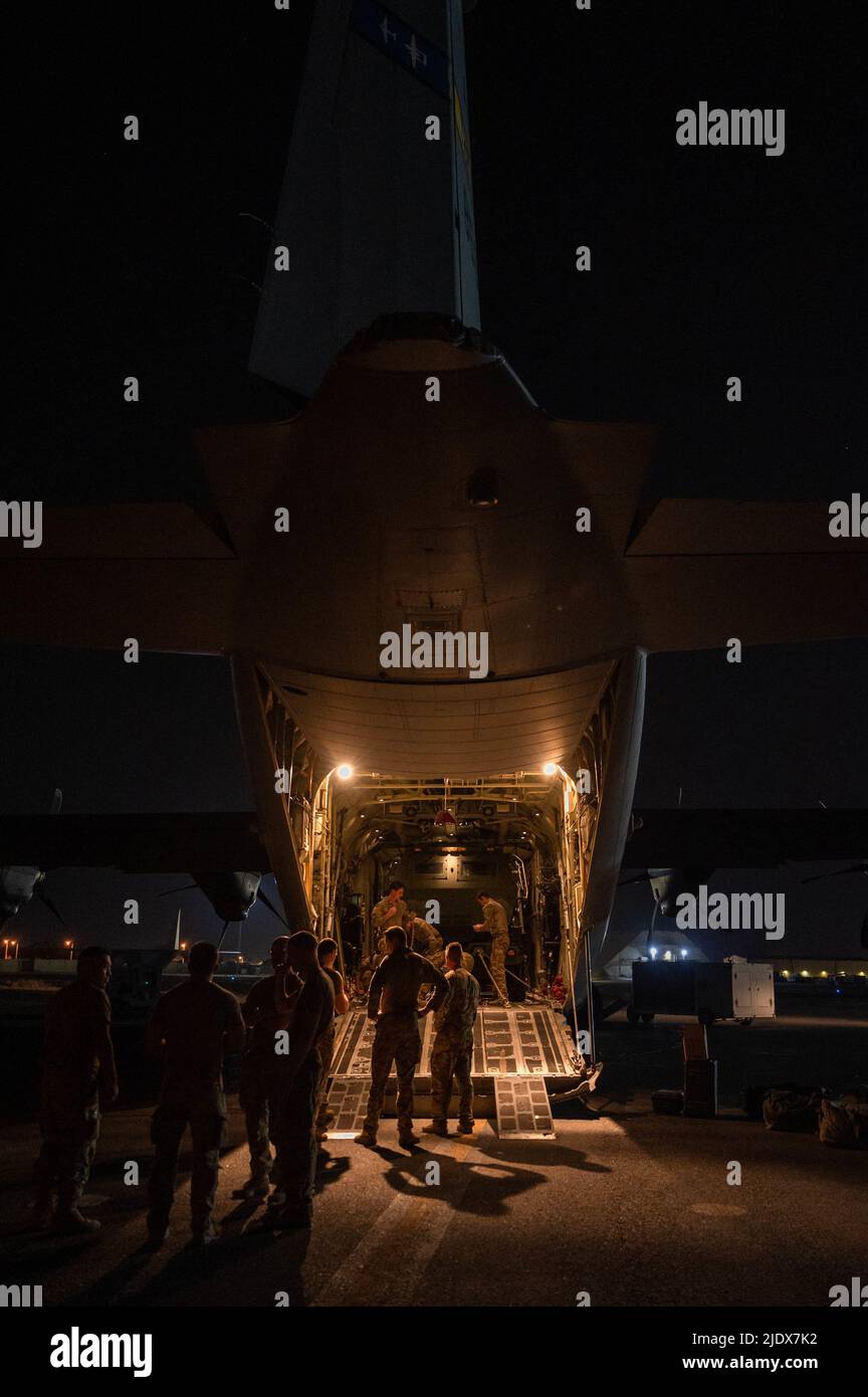 Des aviateurs américains de l'aile expéditionnaire aérienne de 386th et des soldats américains chargent un système de fusée d'artillerie à haute mobilité sur un C-130J Super Hercules affecté au 41st Escadron de transport aérien de la base aérienne d'Ali Al Salem, au Koweït (7 juin 2022). L'AES de 41st transporte du fret vers des régions situées autour de la zone de responsabilité du Commandement central des États-Unis à l'appui de l'opération résolution inhérente. (É.-U. Photo de la Force aérienne par le premier Airman Natalie Filzen) Banque D'Images