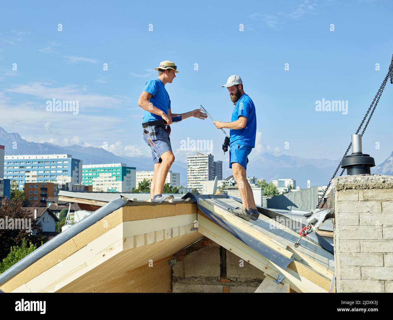 Hommes debout sur le toit de la maison au chantier de construction Banque D'Images