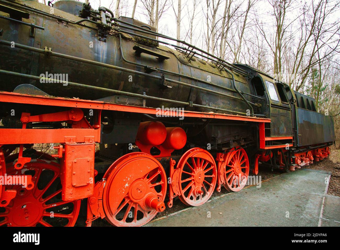 Locomotive à vapeur garée à un terminal. Chemin de fer historique de 1940 en rouge noir. Photo de nostalgie de la technologie passée Banque D'Images