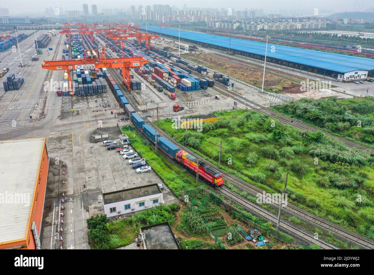 CHONGQING, 24 juin 2022 (Xinhua) -- photo aérienne prise sur 23 juin 2022 montre un train de cargaison, qui marque le 00th 000 voyage effectué par des trains de marchandises Chine-Europe exploités par le train express Chine-Europe (Chongqing), en quittant la gare centrale du village de Tuanjie à Chongqing, dans le sud-ouest de la Chine. Le train de marchandises, entièrement chargé de produits électroniques, de pièces mécaniques et de produits de première nécessité, a quitté jeudi une gare dans la municipalité de Chongqing, dans le sud-ouest de la Chine, et s'est dirigé vers Duisburg en Allemagne. Le China-Europe Railway Express (Chongqing), lancé en mars 2011 Banque D'Images