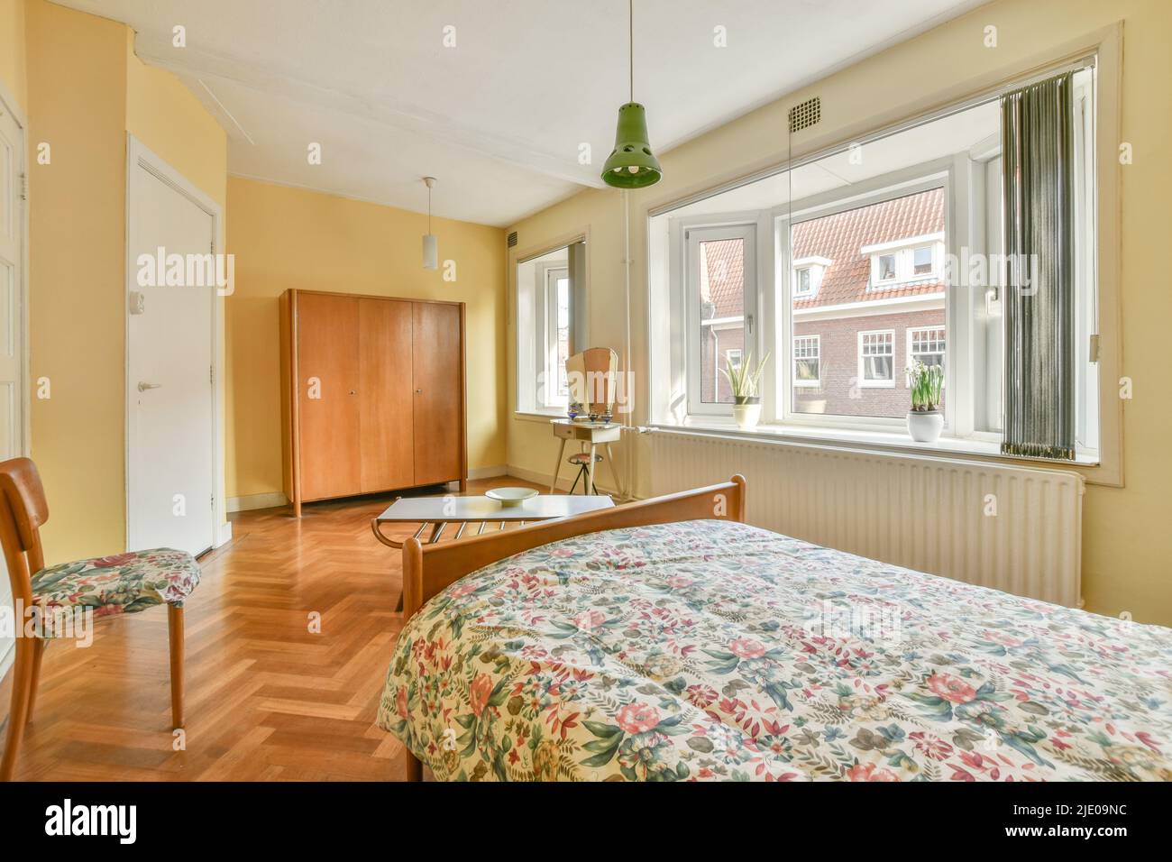 Cette chambre spacieuse et lumineuse dispose de miroirs et d''une grande fenêtre, dans un style minimaliste et moderne Banque D'Images