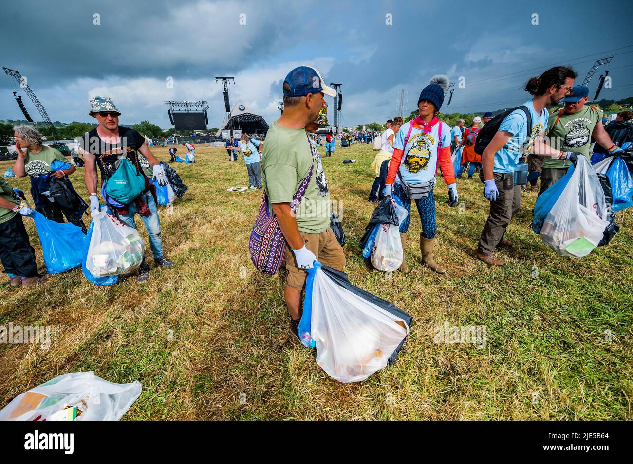 Pilton, Royaume-Uni. 25th juin 2022. Des milliers de bénévoles (beaucoup de collecte d'argent pour les organismes de bienfaisance) nettoient les déchets laissés par les festivaliers la nuit précédente (dans ce cas à l'étape Pyramid). Le travail est nécessaire en dépit de la devise du festival pour «ne laisser aucune trace» - le Glastonbury Festival 50th 2022, digne ferme. Glastonbury, Credit: Guy Bell/Alamy Live News Banque D'Images