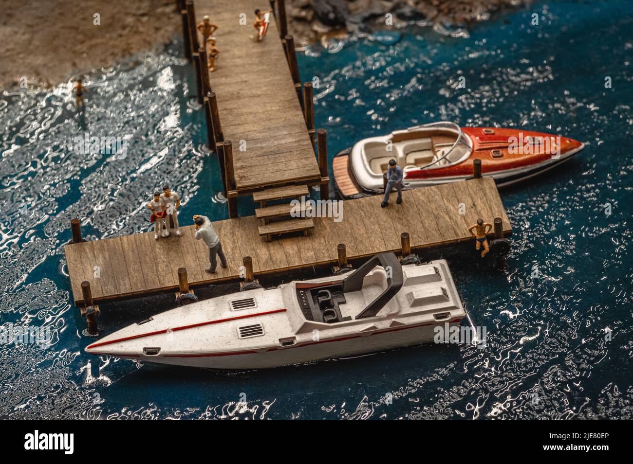 Représentation de jouets de bateaux à moteur de luxe attachés à un quai. Banque D'Images