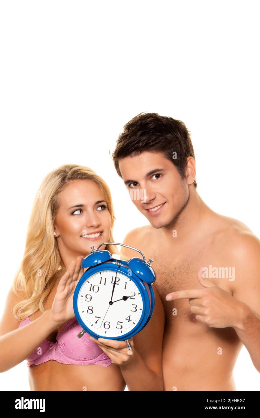Zeitumstellung, Uhrenumstellung, Sommerzeit, Winterzeit, Paar mit Wecker, 25, 30, Jahre, Banque D'Images