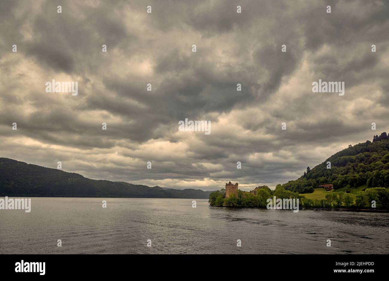 Les ruines de la forteresse médiévale de 16th siècles Château d'Urquhart sur les rives du Loch Ness dans le Grand Glen dans les Highlands d'Écosse, de lourds nuages Banque D'Images