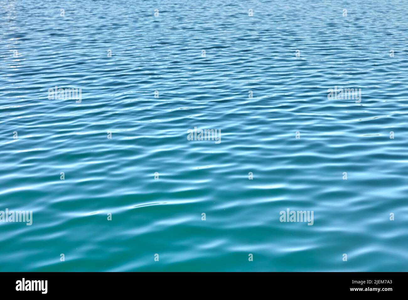 Arrière-plan d'eau avec ondulations et recopie. Gros plan sur l'eau fraîche et bleue de l'océan à marée basse. Zoom avant sur la surface de l'eau ondulée avec unique Banque D'Images