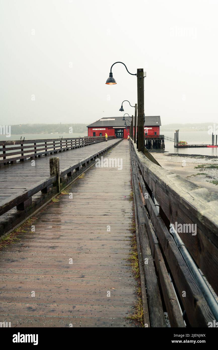 Vue depuis Coupeville Washington sur l'île Whidbey avec jetée et bâtiment historique en vue, par temps de pluie Banque D'Images