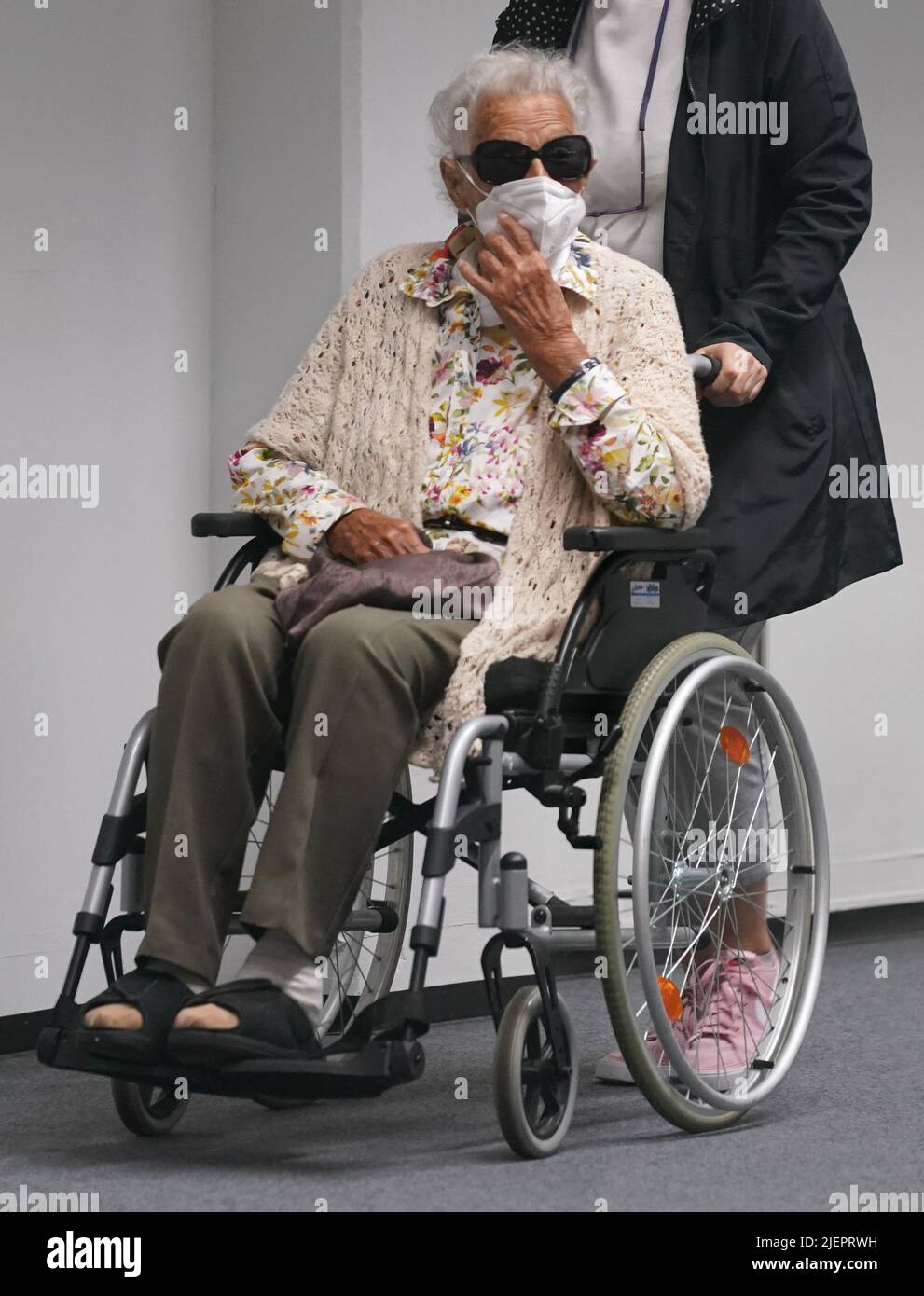 Itzehoe, Allemagne. 28th juin 2022. Le défendeur Irmgard F., âgé de 97 ans, est accompagné dans la salle d'audience au début de la journée d'audience par un employé du service médical judiciaire. L'ancien secrétaire est accusé de complicité dans le meurtre de plus de 11 000 personnes dans le camp de concentration de Stutthof. Credit: Marcus Brandt/dpa/Alay Live News Banque D'Images