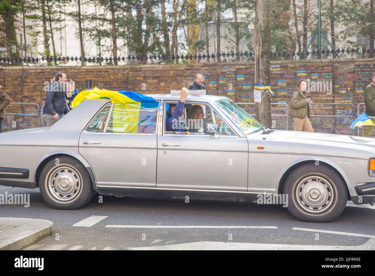 Un automobiliste affichant des drapeaux ukrainiens sur la voiture passe devant l'ambassade de Russie à Londres. Banque D'Images