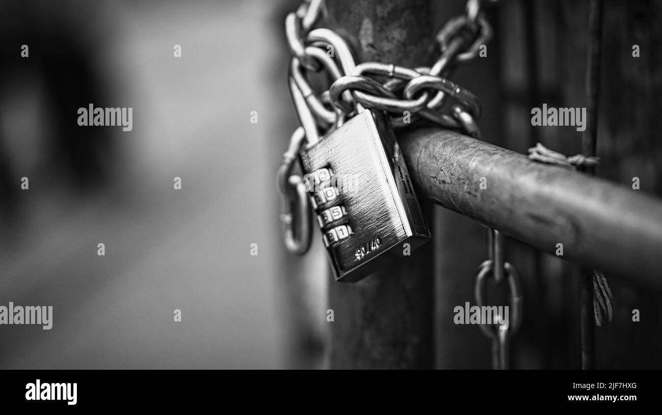 Cadenas blanc noir sur une chaîne. Verrouillé et verrouillé. Mystérieux et sûr. Photo détaillée Banque D'Images