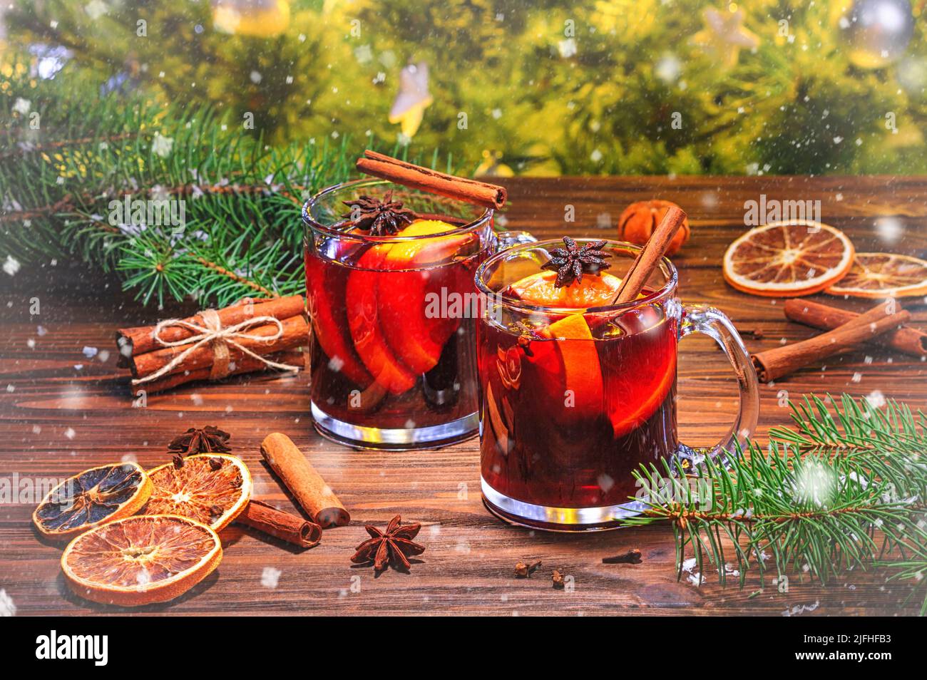 Vin rouge de Noël chaud aux épices aromatiques et aux agrumes sur une table rustique en bois, en gros plan.Boisson chaude traditionnelle à Noël ou ne Banque D'Images