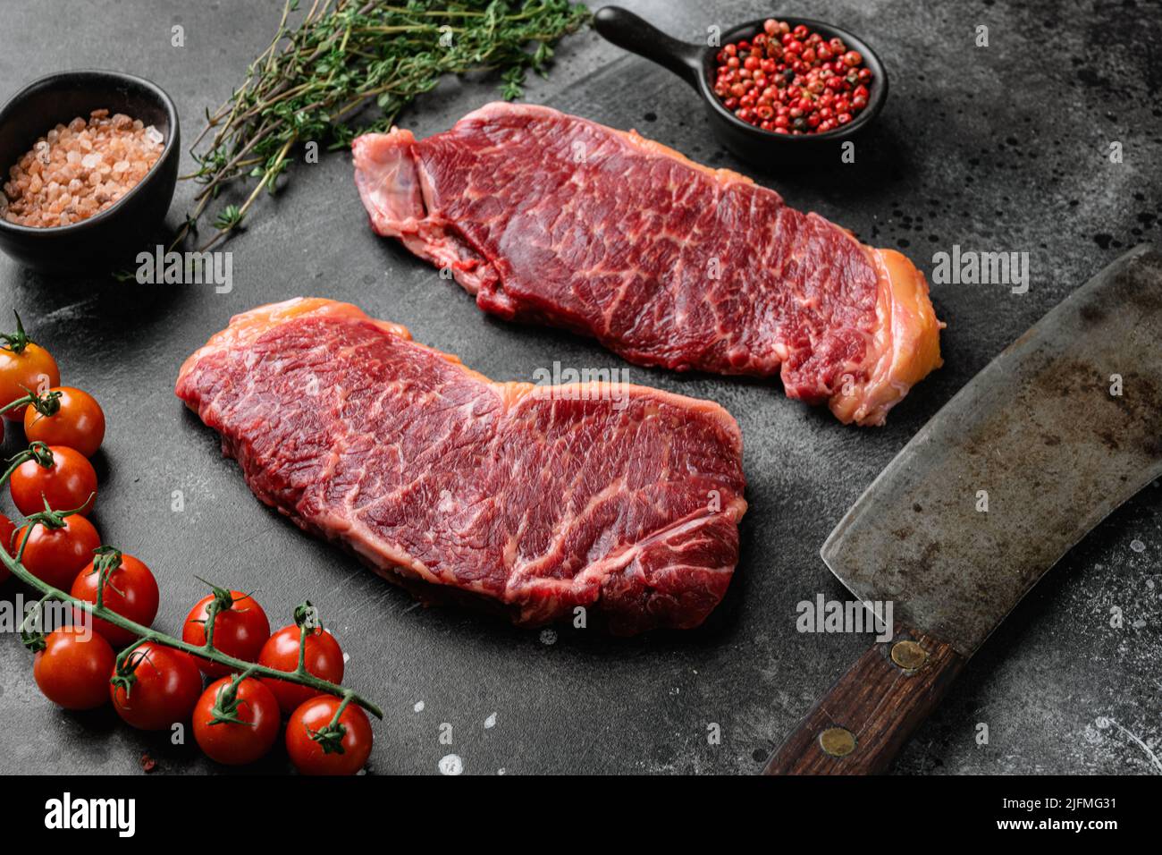 Steak New-yorkais, sur fond de table noir en pierre sombre Banque D'Images