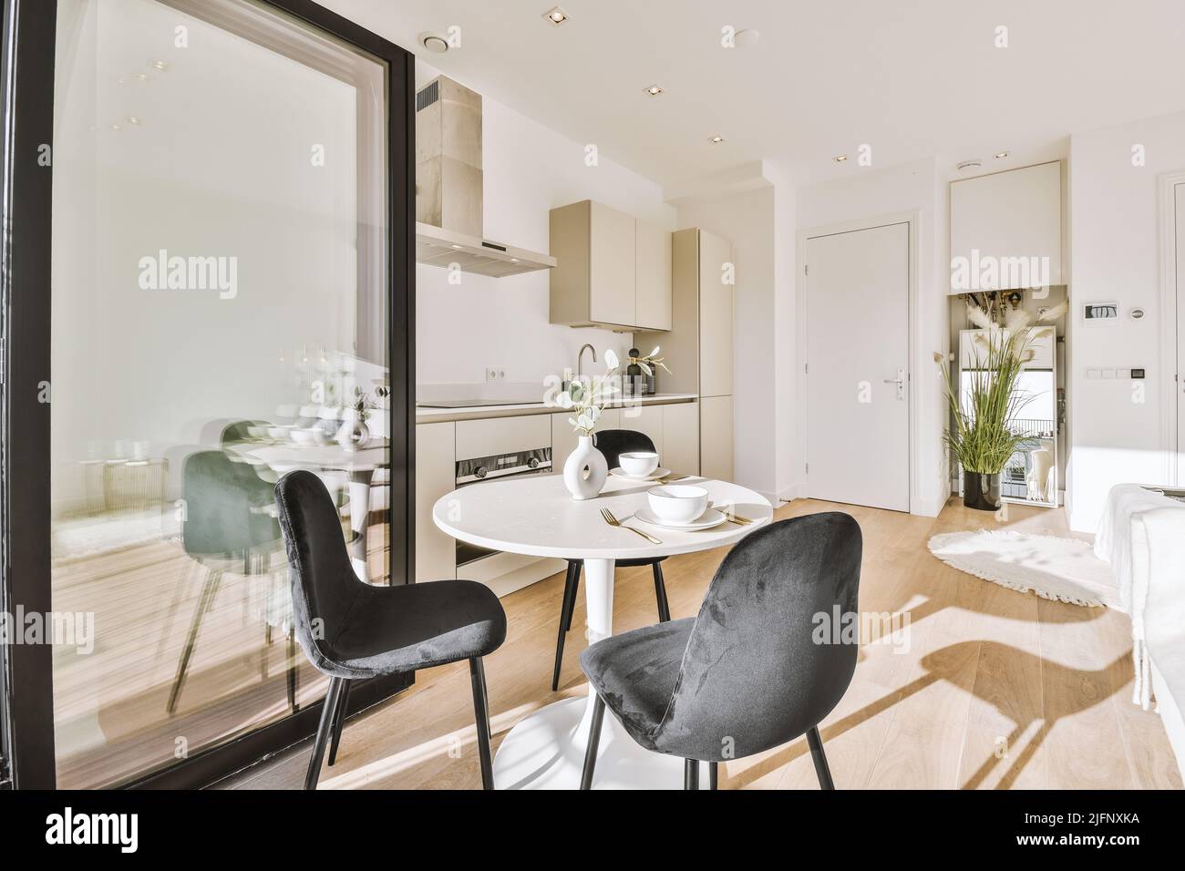 Décoration intérieure d'appartement moderne avec cuisine ouverte de style minimaliste et grande salle à manger avec table et chaises Banque D'Images