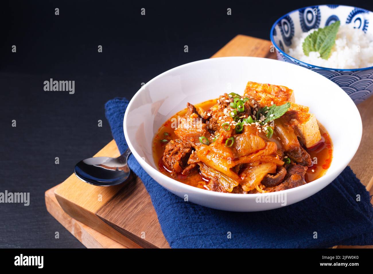 Cuisine asiatique concept fait maison Kimchi Beef ragoût Kimchi jjigae sur bois et pierre d'ardoise noire avec espace de copie Banque D'Images