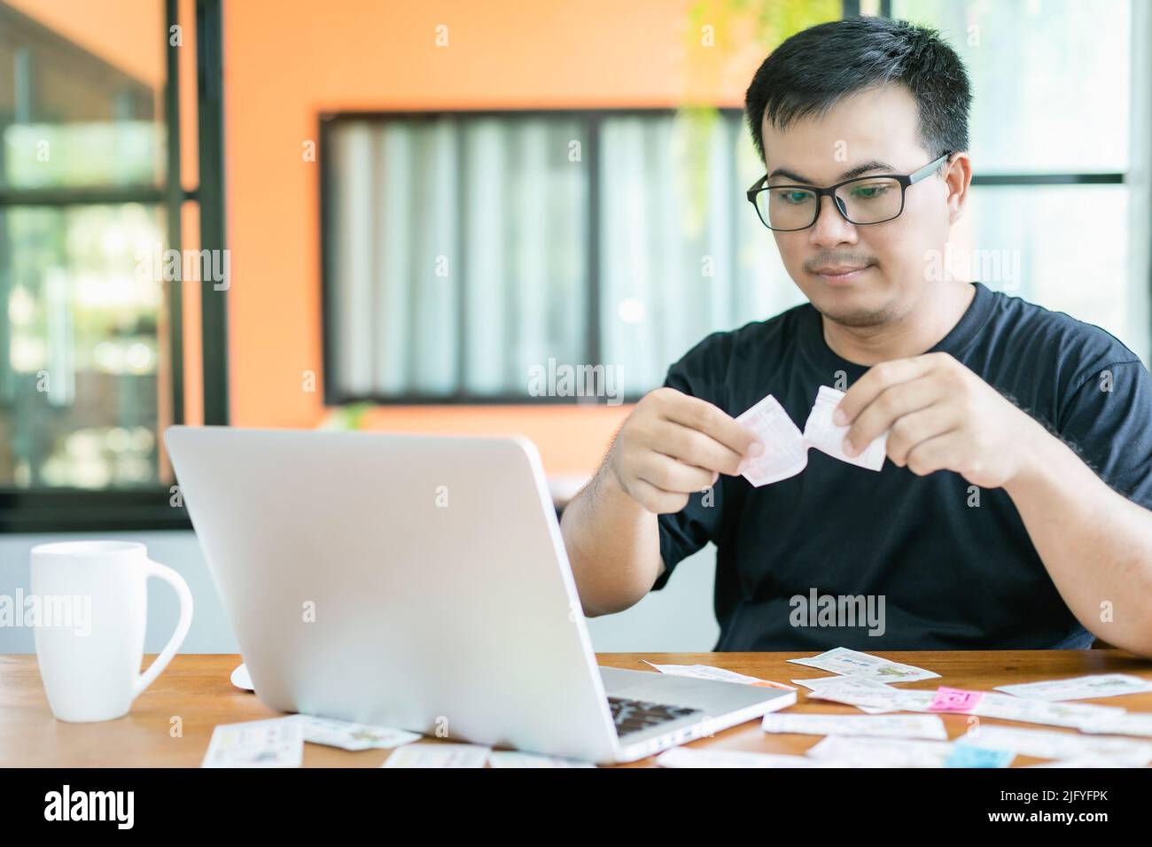 Sentiment d'échec sur le concept de loterie du gouvernement : les gens thaïlandais vérifiant le résultat de la loterie du gouvernement thaïlandais sur ordinateur portable et de l'abattage échouent ou triste. Séle Banque D'Images