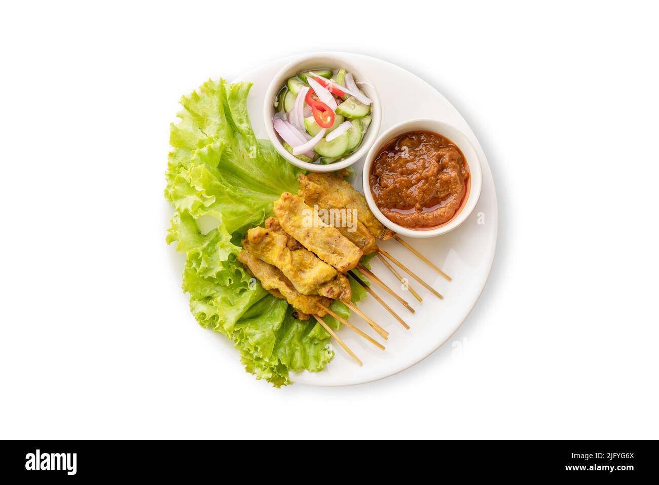 Vue de dessus. Satay de porc avec sauce à l'arachide et cornichons qui sont des tranches de concombre et des oignons dans le vinaigre. Isolé sur fond blanc Banque D'Images