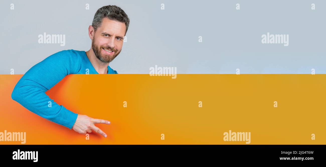 Homme visage portrait, bannière avec espace de copie. Homme derrière papier papier bannière vierge avec espace de copie pour la publicité show Peace Gesture, annonce. Banque D'Images