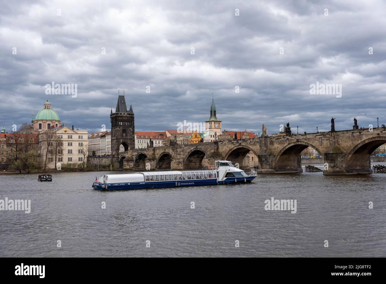 Bateau touristique sur la Vltava, le Pont Charles, la Tour du Pont de la Vieille ville, l'Eglise de la Sainte Croix, Prague, République Tchèque Banque D'Images
