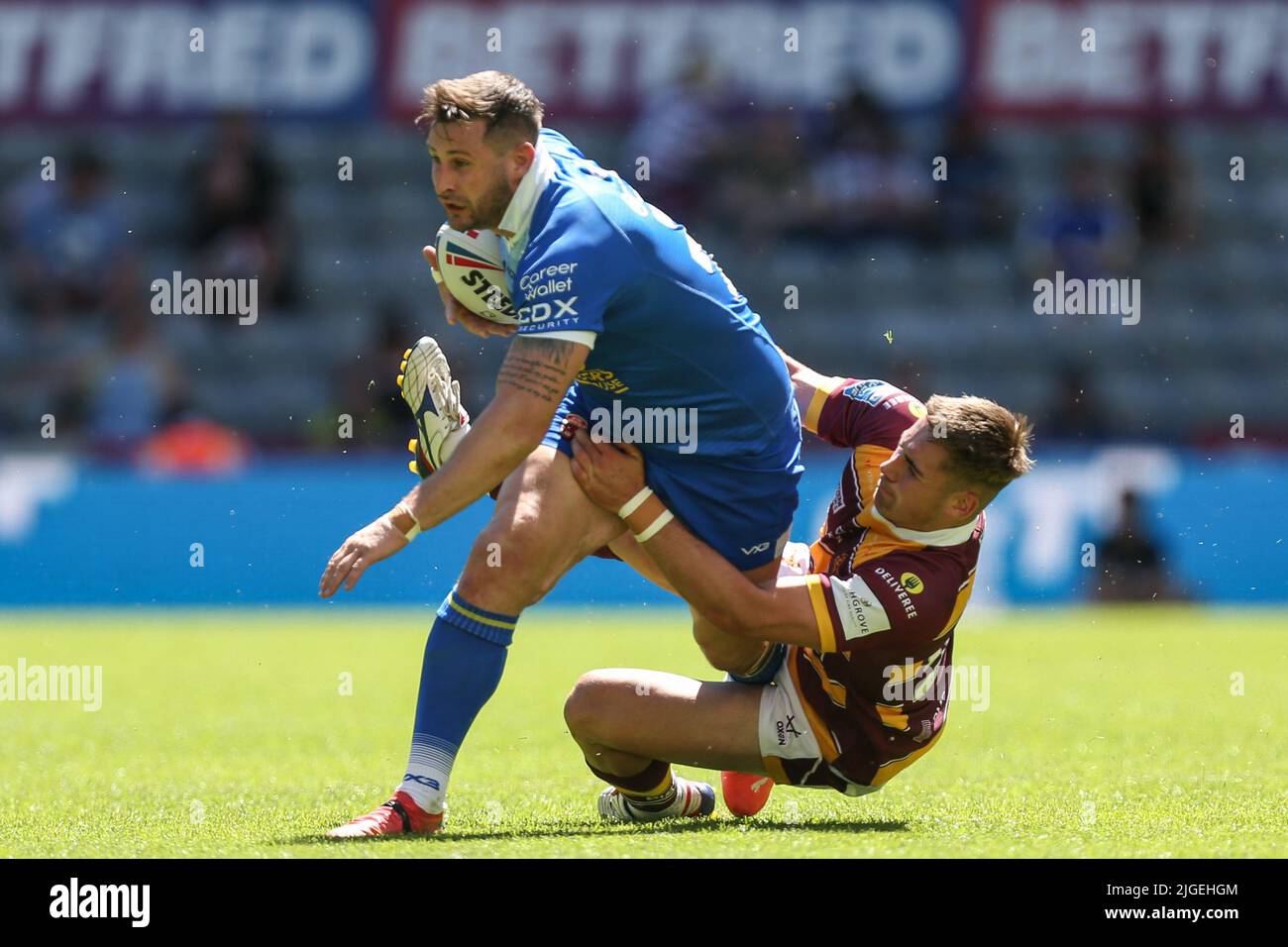 Alex Gerrard #3 de Salford Red Devils est attaqué par Sam Hewitt #29 de Huddersfield Giants Banque D'Images