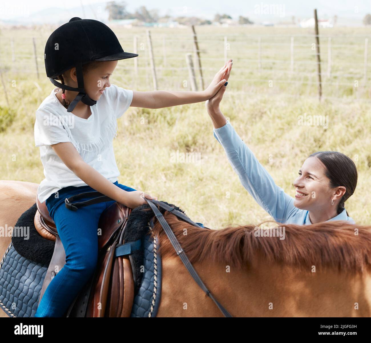 Mon apprenant préféré. Jeune fille avec son instructeur avec un cheval en plein air dans une forêt. Banque D'Images