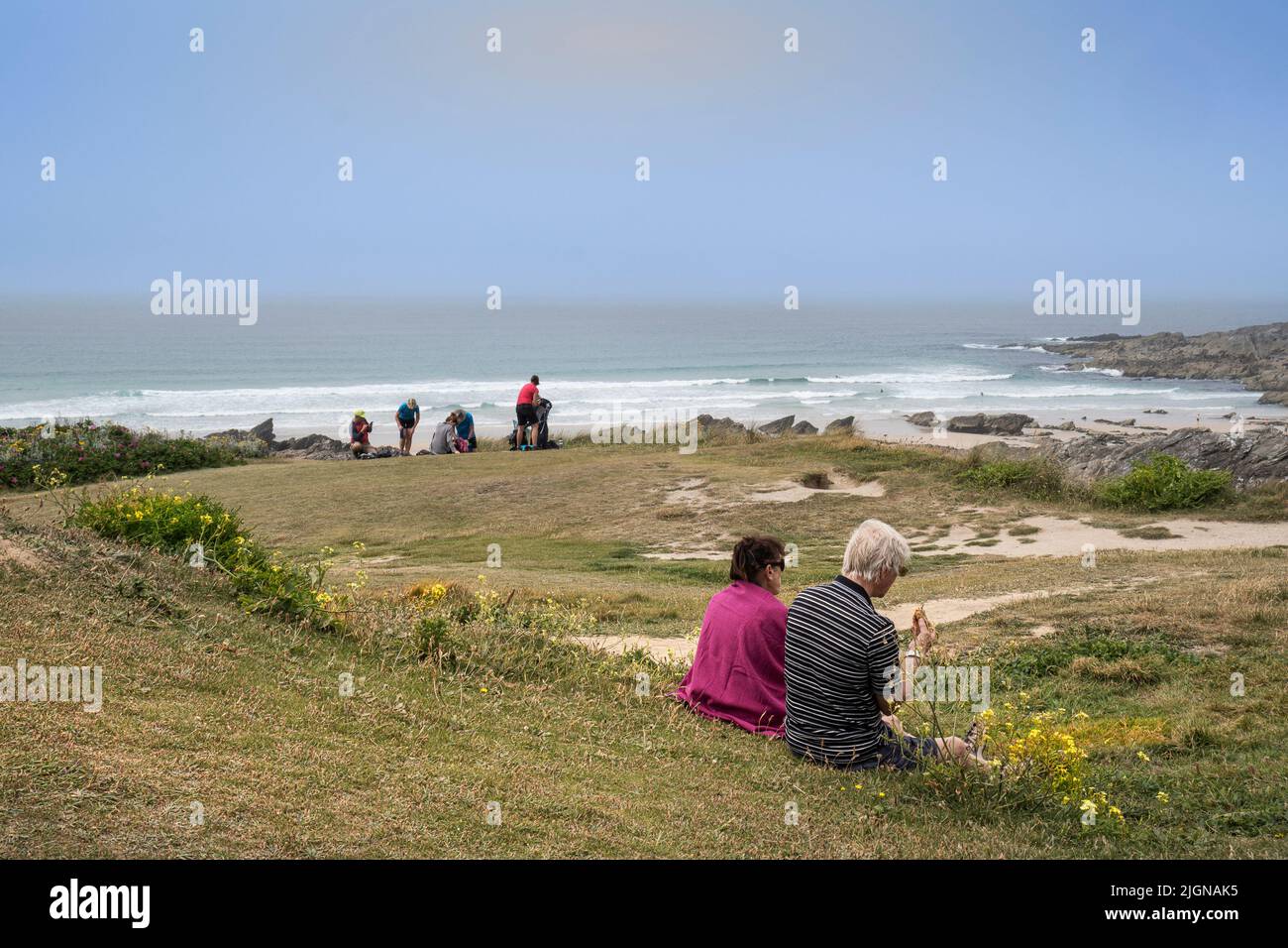 Vacanciers se détendant tandis que la brume marine se déforme sur la côte à Newquay, en Cornouailles, au Royaume-Uni. Banque D'Images