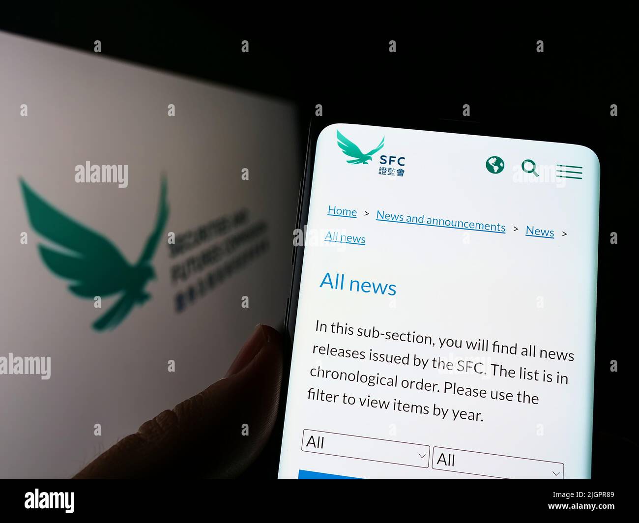 Personne détenant un smartphone avec une page Web de la Commission des valeurs mobilières et des contrats à terme de Hong Kong (SFC) à l'écran avec logo. Concentrez-vous sur le centre de l'écran du téléphone. Banque D'Images