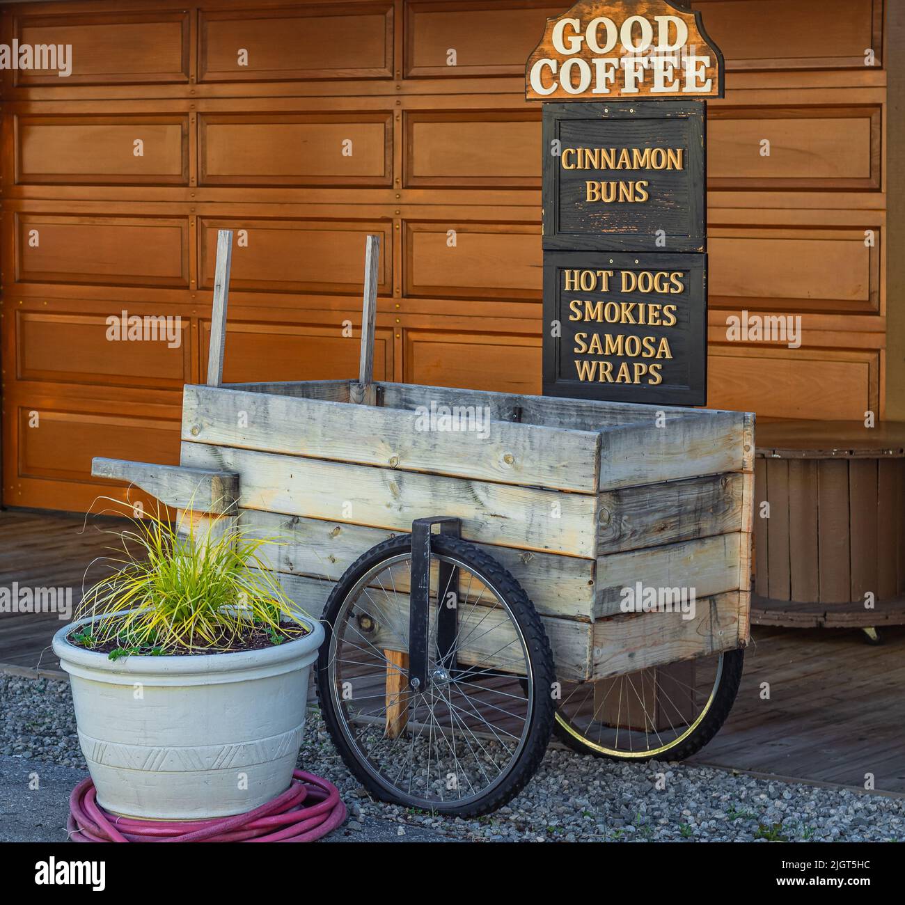 Un comptoir ou un comptoir commercial stylisé comme un ancien chariot. Une voiturette en bois vintage dans une rue. Un distributeur de vélos en bois. Personne, photo de rue. Banque D'Images