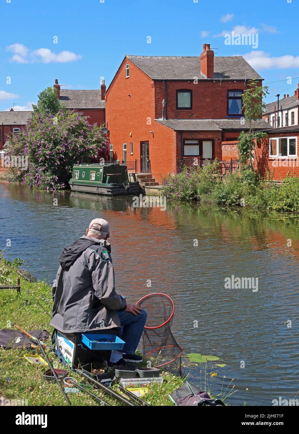 Homme pêchant sur le canal de Bridgewater - branche de Leigh, Wigan, Lancashire, Angleterre, Royaume-Uni, WN7 3AE Banque D'Images
