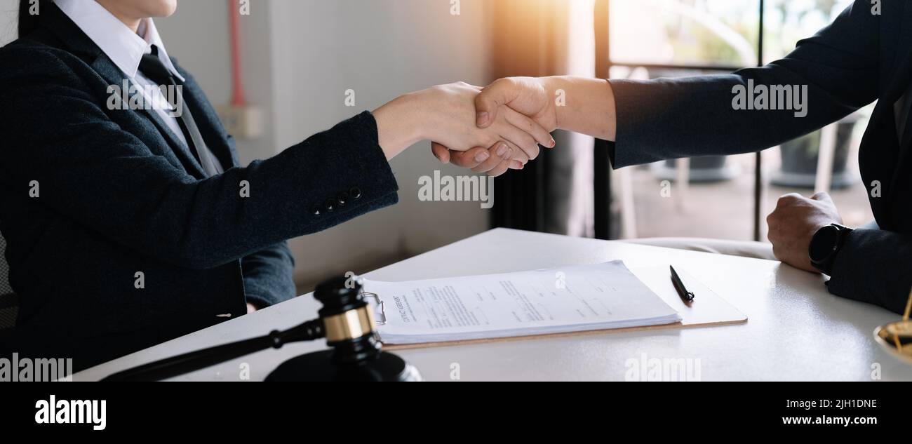 L'avocat se fait une poignée de main avec le client pour féliciter et confirmer l'accord au cabinet d'avocats. Banque D'Images