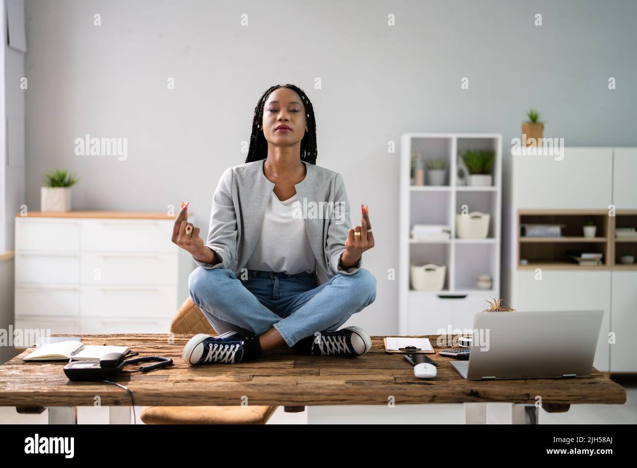 Un employé africain faisant de la santé mentale Yoga Méditation en bureau Banque D'Images