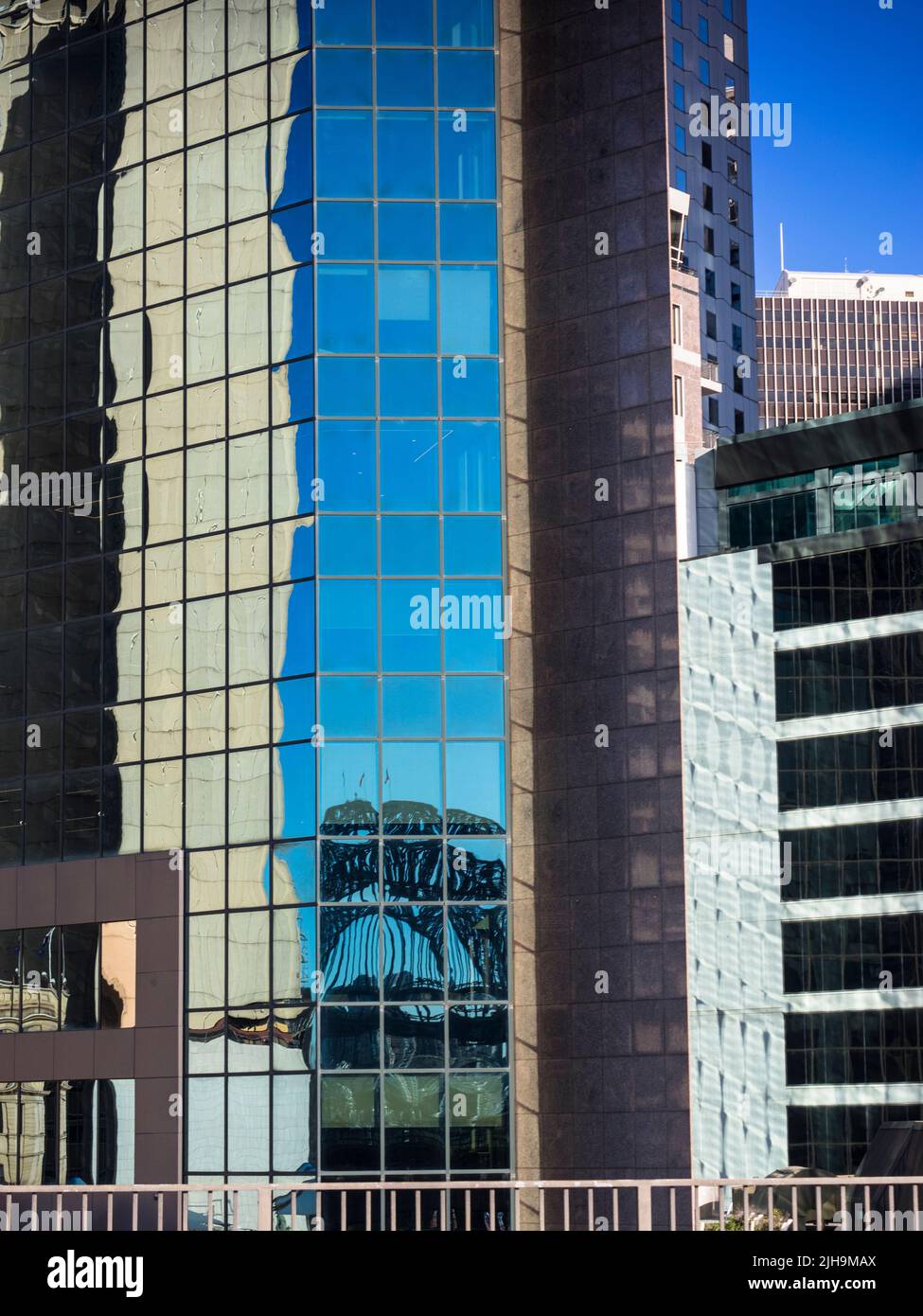 Le Sydney Harbour Bridge se reflète dans un immeuble de bureaux moderne à Circular Quay. Banque D'Images