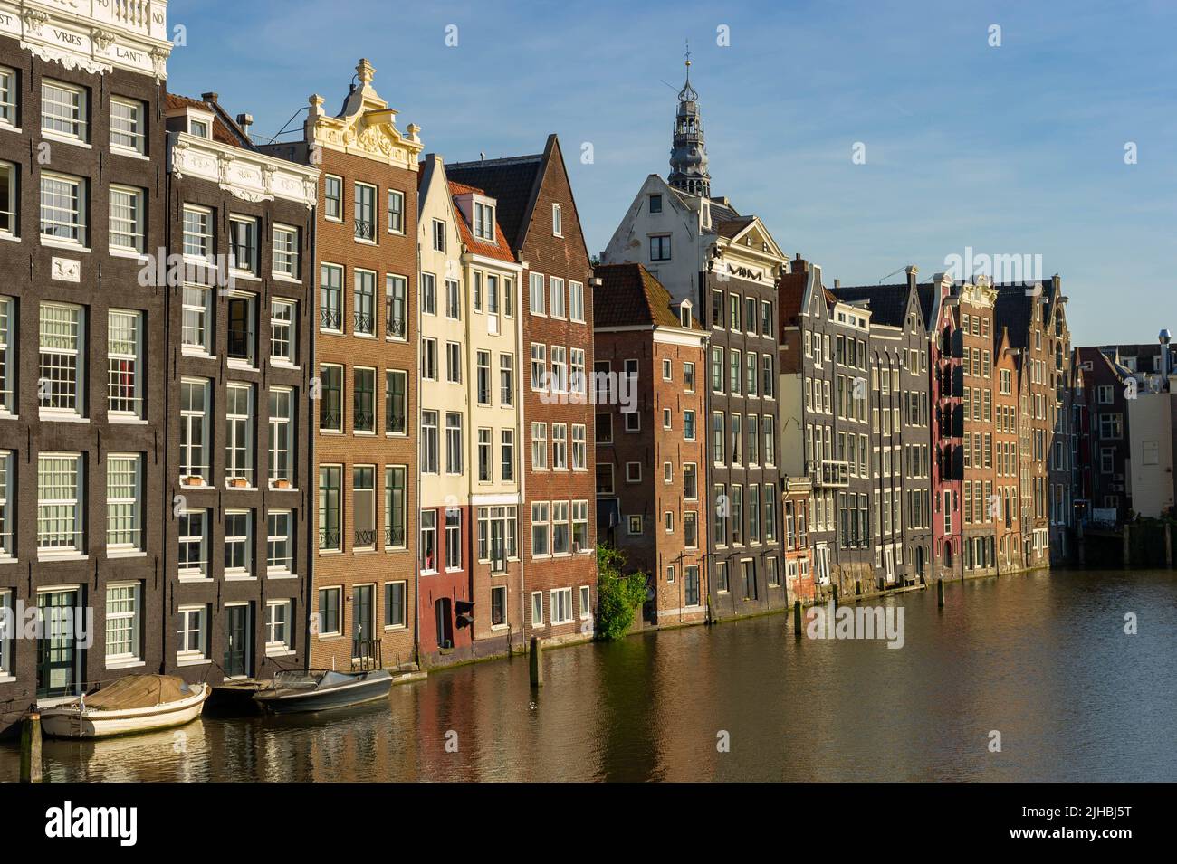 Maisons hollandaises sur le Damrak à Amsterdam au coucher du soleil Banque D'Images