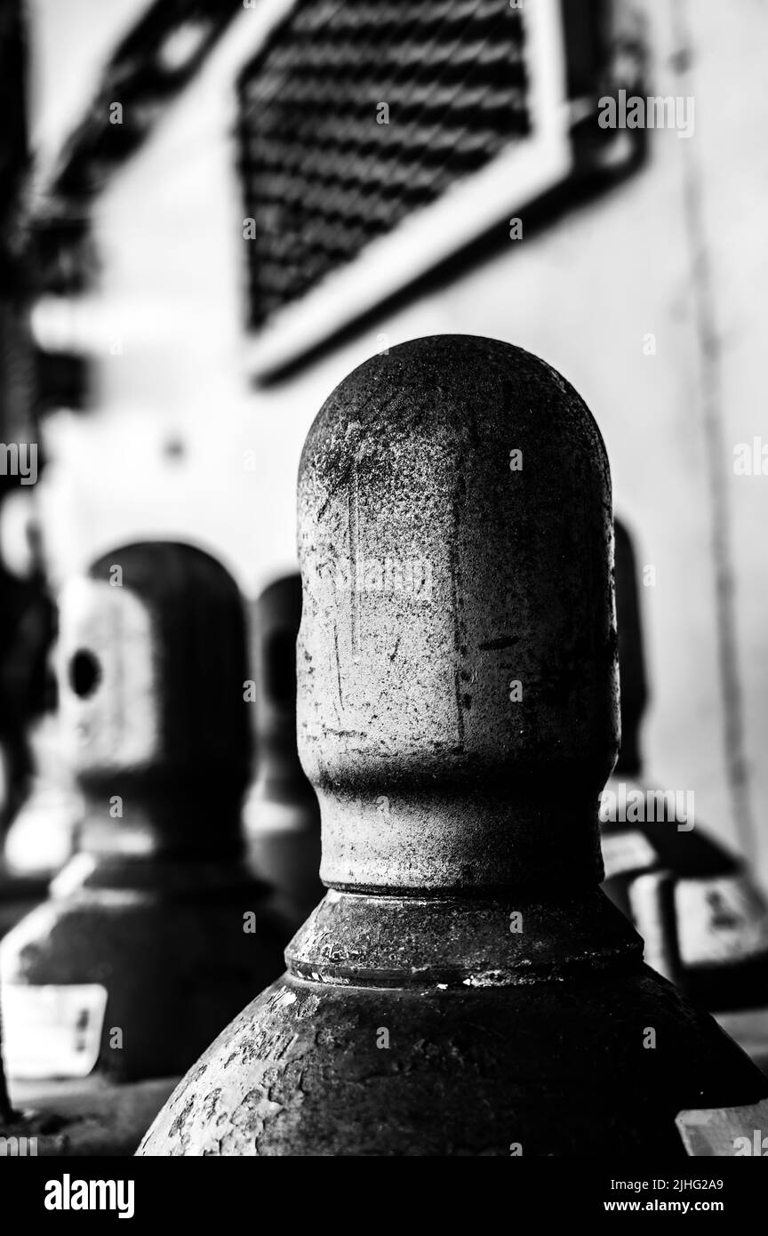 Bouteilles de gaz comprimé stockées verticalement fixées par une chaîne métallique et un bouchon en métal. Banque D'Images