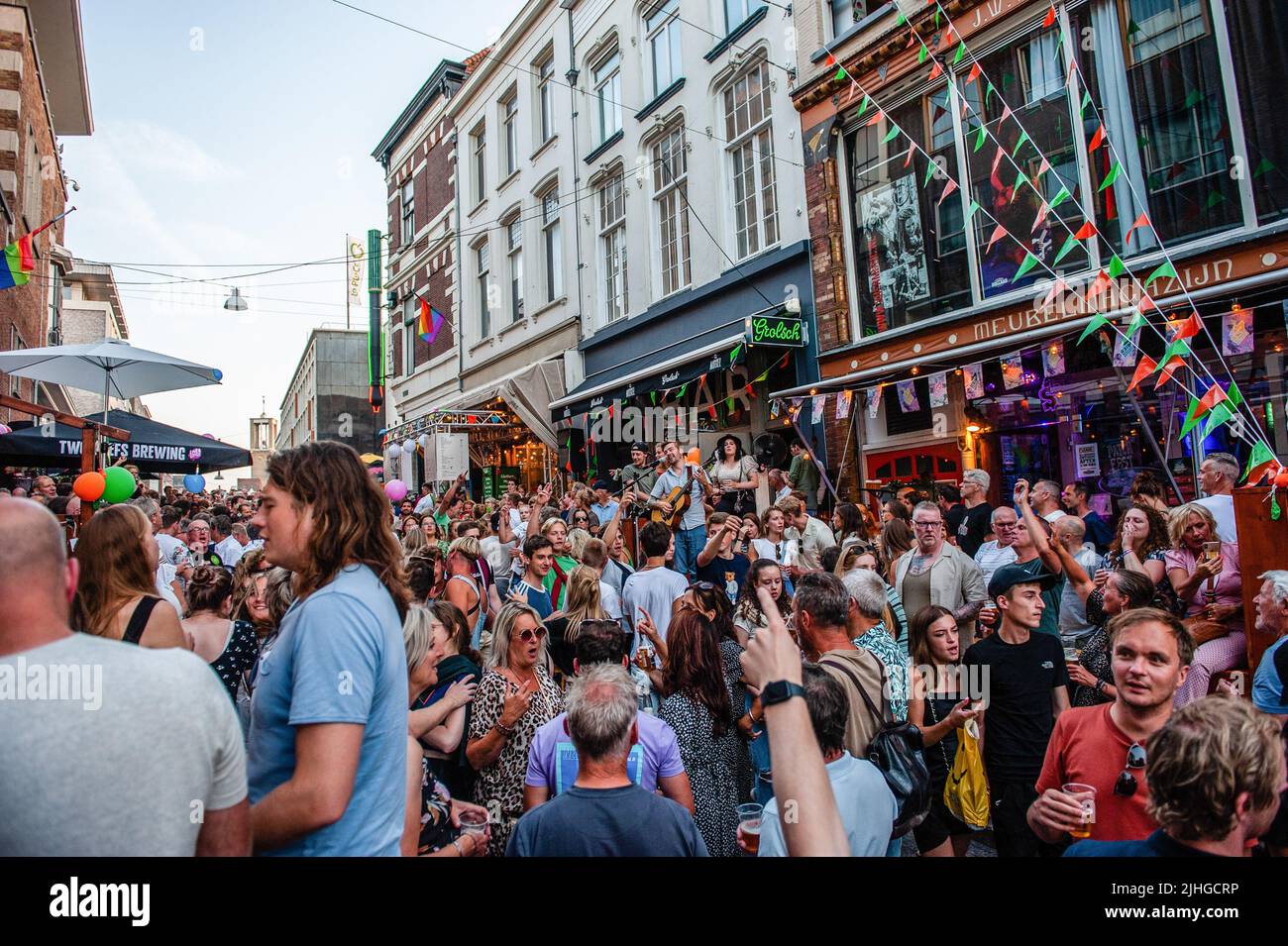 Un homme a vu jouer de la musique au milieu des gens dansant dans la rue. Le Vierdaagsefeesten (en anglais, ce qui signifie quelque chose comme la fête de quatre jours) est le plus grand événement librement accessible aux pays-Bas et le quatrième en Europe. Le Vierdaagsefeesten se tient en même temps que les Marches internationales de quatre jours, le plus grand événement de marche de plusieurs jours au monde. Chaque année, cet événement présente un programme qui attire les gens pour faire plus de 1,5 millions de visites dans le centre-ville de Nimègue, la plus ancienne ville des pays-Bas. La fête commence le week-end avant le f Banque D'Images Un homme a vu jouer de la musique au milieu des gens dansant dans la rue. Le Vierdaagsefeesten (en anglais, ce qui signifie quelque chose comme la fête de quatre jours) est le plus grand événement librement accessible aux pays-Bas et le quatrième en Europe. Le Vierdaagsefeesten se tient en même temps que les Marches internationales de quatre jours, le plus grand événement de marche de plusieurs jours au monde. Chaque année, cet événement présente un programme qui attire les gens pour faire plus de 1,5 millions de visites dans le centre-ville de Nimègue, la plus ancienne ville des pays-Bas. La fête commence le week-end avant le f Banque D'Images