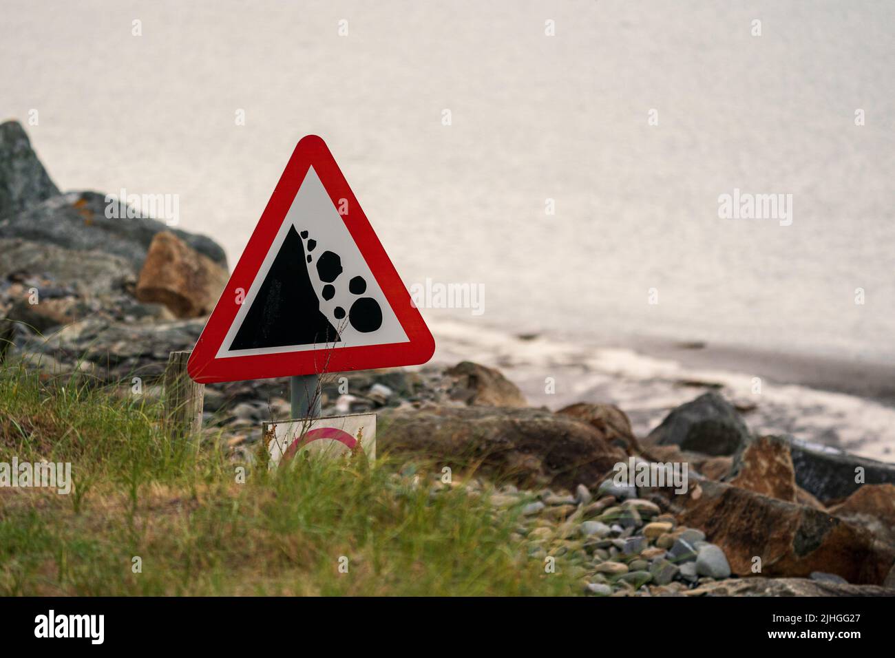 danger signe d'avertissement possibilité de glissement de terrain de roche tomber sur la plage à la côte Banque D'Images